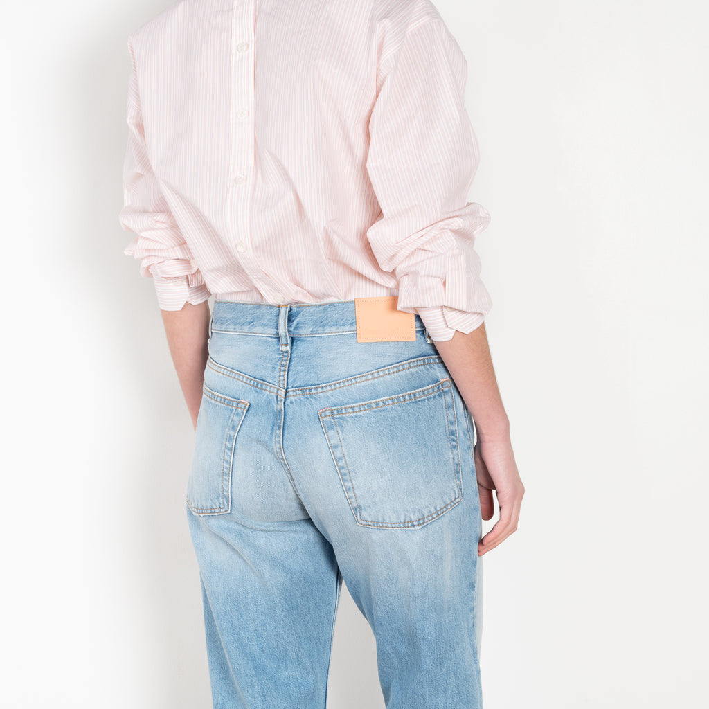 The 2021 Loose Fit Jeans by Acne Studios are cut to a loose fit with mid-waist, wide leg and long length