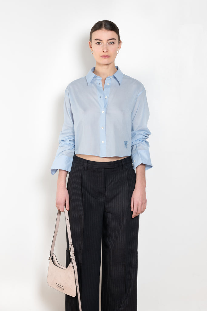 The Bow Embroidery Shirt by Acne Studios is crafted from light poplin cotton, detailed with a bow embroidery at the front. Cut to a relaxed fit and cropped length.