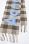 The Check Logo Scarf by Acne Studios features an all-over check pattern, contrast jacquard woven fil coupé Acne Studios logo, crafted from a rich wool blend