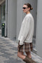 The Pleated Skirt 736 by Acne Studios has a pleated assymetric fit with and adjustable belt above the waist and raw-edge finishes