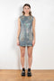 The Coated Denim Dress by Acne Studios is a sleeveless cotton denim twill dress with an iridescent and coated finish
