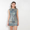 The Coated Denim Dress by Acne Studios is a sleeveless cotton denim twill dress with an iridescent and coated finish