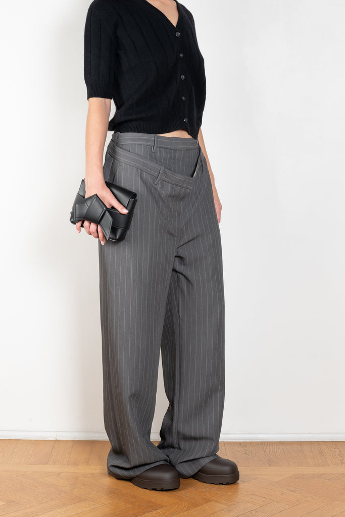 The Deconstructed Pinstripe Trouser by Acne Studios feature a classic pinstripe pattern, characterised by a deconstructed double-layered belt loop and waist