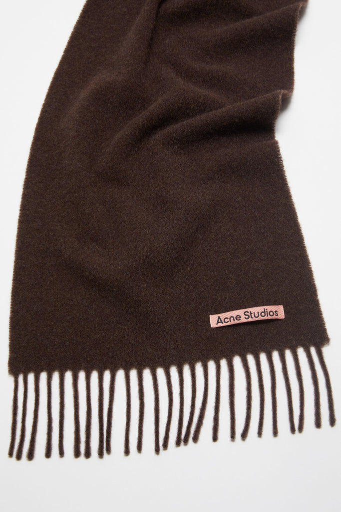 The Fringe Wool Scarf Skinny by Acne Studios is detailed with a pink Acne Studios label, crafted from midweight wool