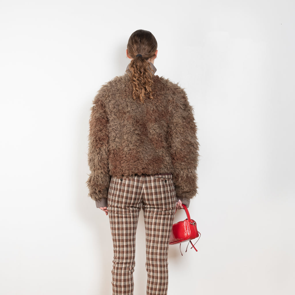 The Furry Jacket by Acne Studios has a bi-coloured furry finish with a ribbed neckline