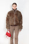 The Furry Jacket by Acne Studios has a bi-coloured furry finish with a ribbed neckline