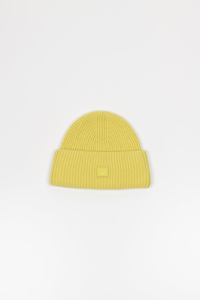 The Small Face Logo Beanie by Acne Studios features a small embroidered face logo patch and ribbed detailing, crafted from chunky wool.