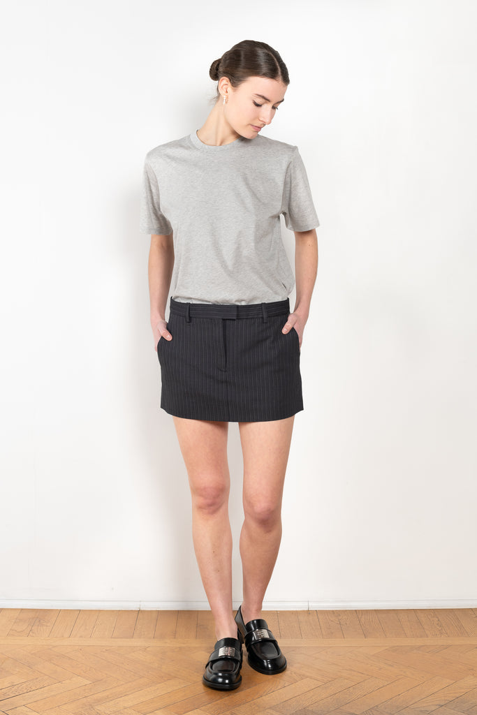 The Pinstripe Skirt by Acne Studios is a mini skirt in a wool cotton blend yarn with a barré pinstripe design