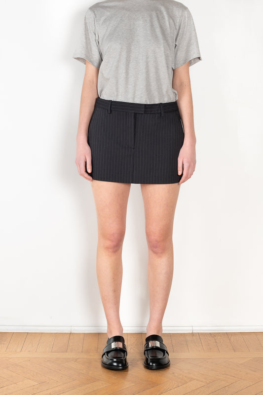 The Pinstripe Skirt by Acne Studios is a mini skirt in a wool cotton blend yarn with a barré pinstripe design