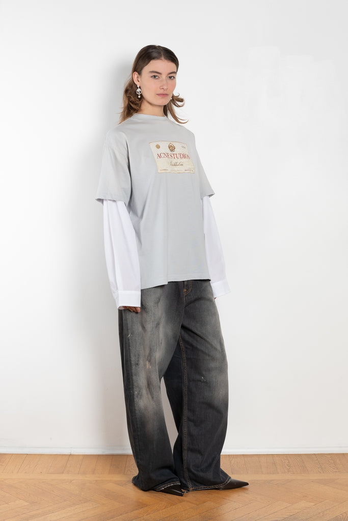 The Layered Print Tee by Acne Studios has a relaxed fit with under-layer mesh long sleeves and distressed neckline