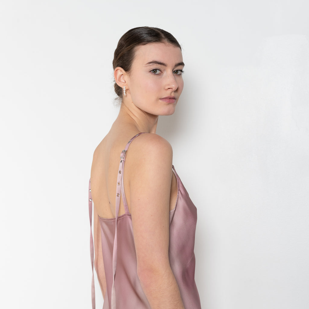 The Strap Dress by Acne Studios is an elegant dress with a printed effect in a fluid satin fabric, detailed with adjustable shoulder straps with a buckle closure