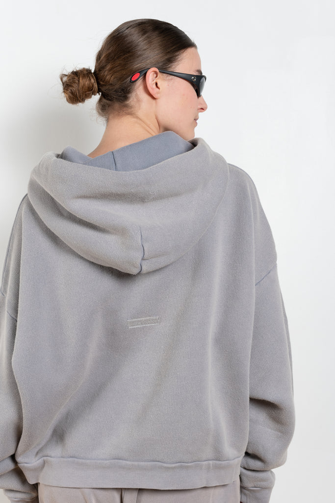 The Hooded Sweater 0019 by Acne Studios is a signature hoodie sweater with a small rubber logo patch on the back