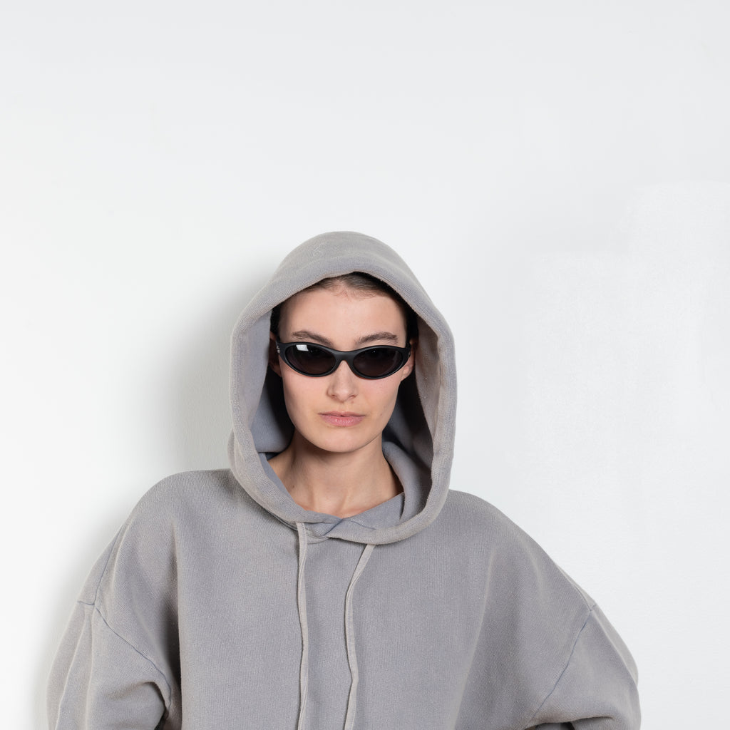 The Hooded Sweater 0019 by Acne Studios is a signature hoodie sweater with a small rubber logo patch on the back