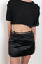 The Keren Mini Skirt by Anna October is a satin mini skirt with a lingerie inspired straps in the waist