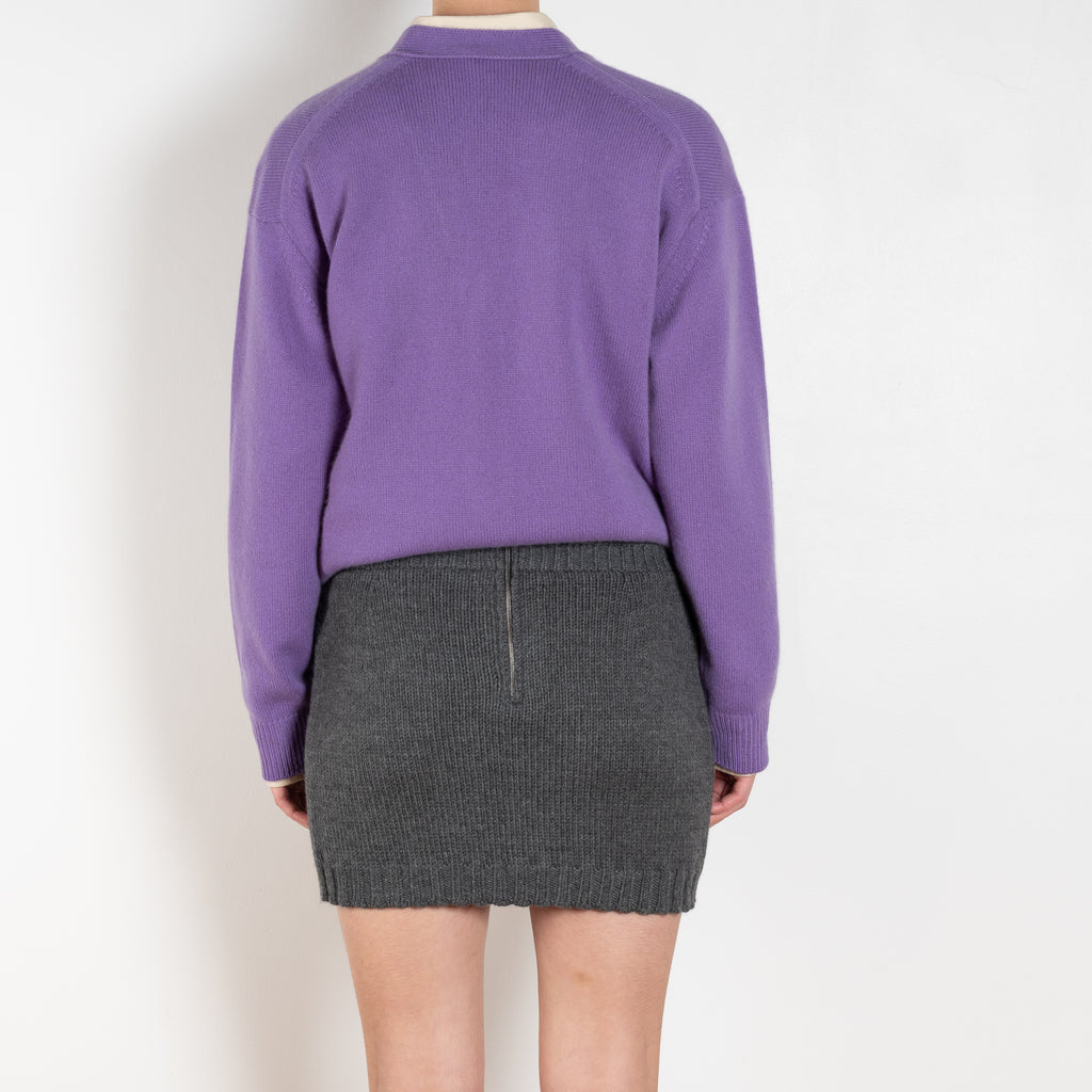 The Cord Mini Skirt by AURALEE is a knitted mini skirt with a double waistband and ribbed trim.