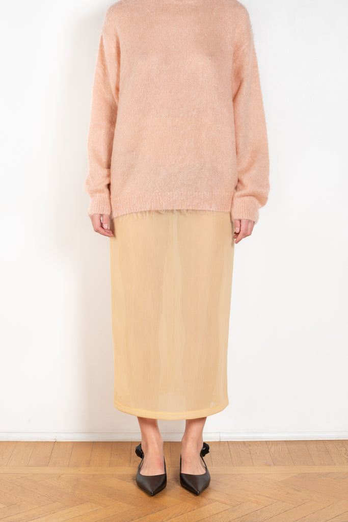 The Elastic Sheer Skirt by Auralee is a long straight skirt with a back slit made fom a unique material