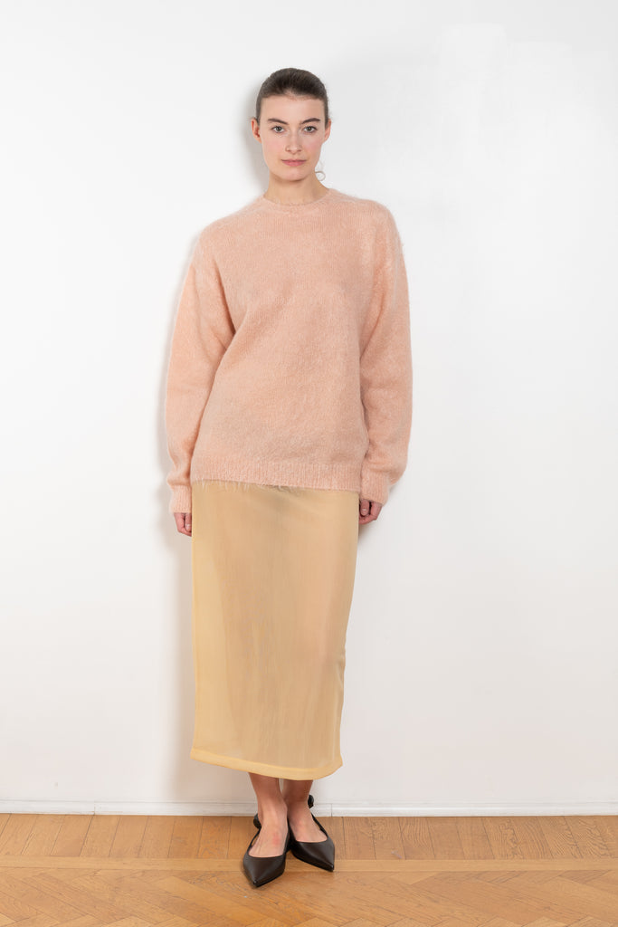 The Elastic Sheer Skirt by Auralee is a long straight skirt with a back slit made fom a unique material