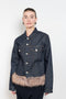 The Faux Fur Hem Denim Jacket by Coperni is a denim jacket with a faux fur waistband at the front