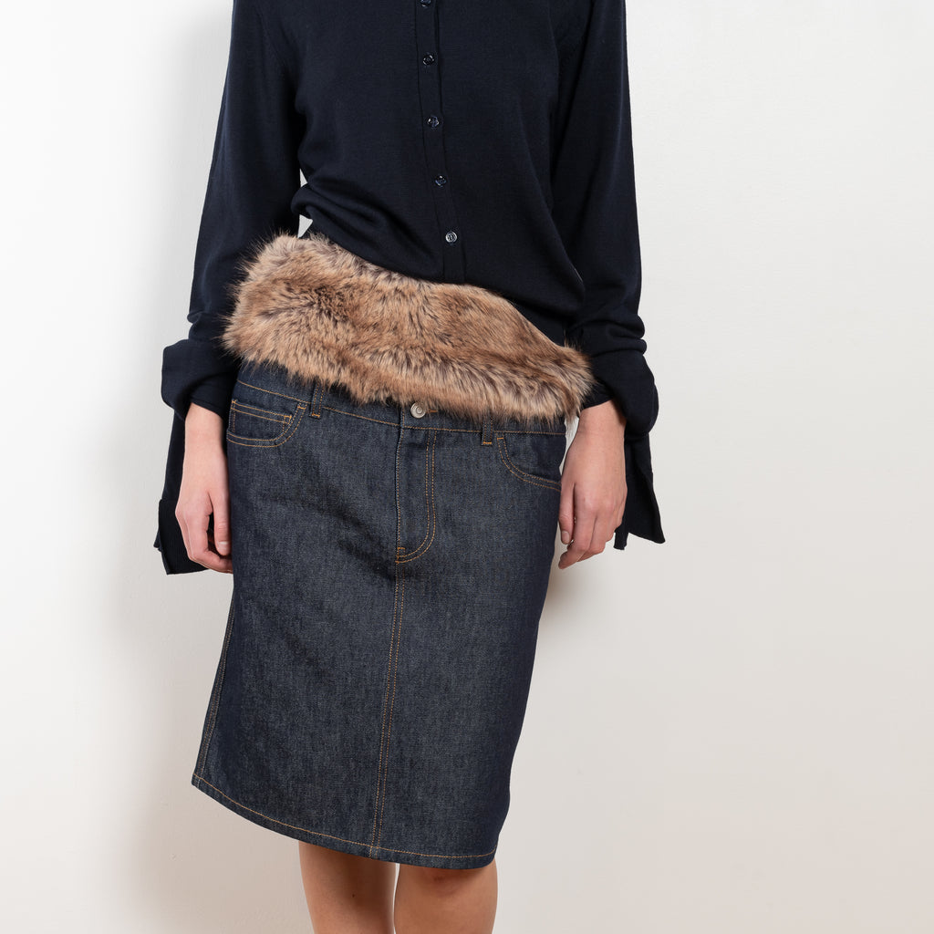 The Faux Fur Hybrid Denim Skirt by Coperni is a denim skirt with an optic low waist and faux fur waistband at the front