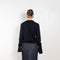 Knotted Sleeved Cardigan by Coperni is a navy cotton cardigan with extra long sleeves which are meant to be tied up in a knot