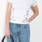 The Petal Embroidered Tshirt by Coperni is a fitted Tee with a small Coperni logo and seasonal petal cut-outs