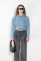 The Workwear Denim Jacket by Coperni is a cropped denim jacket with a zip closure and minimal details