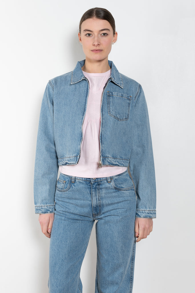 The Workwear Denim Jacket by Coperni is a cropped denim jacket with a zip closure and minimal details