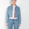 The Workwear Denim Jacket by Coperni is a cropped denim jacket with a zip closure and minimal details