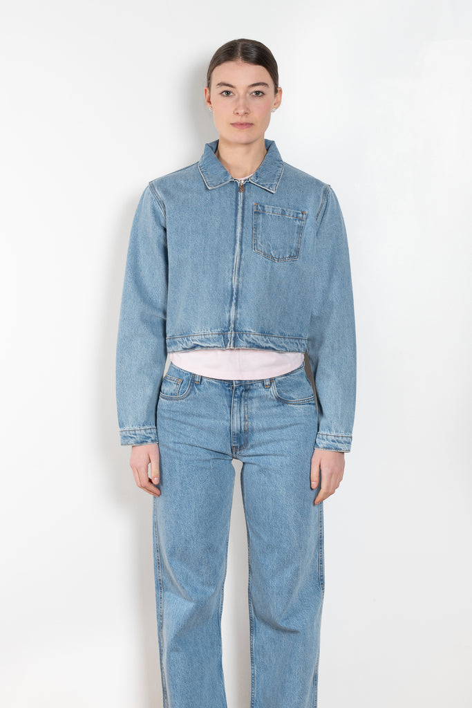 The Workwear Denim Jacket by Coperni is a cropped denim jacket with a zip closure and minimal details