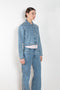 The Workwear Denim Jacket by Coperni is a cropped denim jacket with a zip closure and minimal details