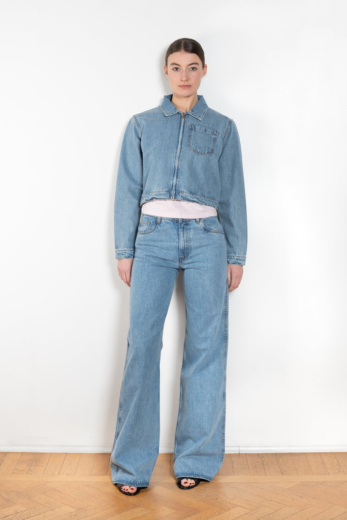 The Workwear Denim Jacket by Coperni is a cropped denim jacket with a zip closure and minimal details