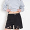 The Petal Embroidered Shorts by Coperni are boxer inspired shorts with a coperni logo patch and seasonal petal cut-outs