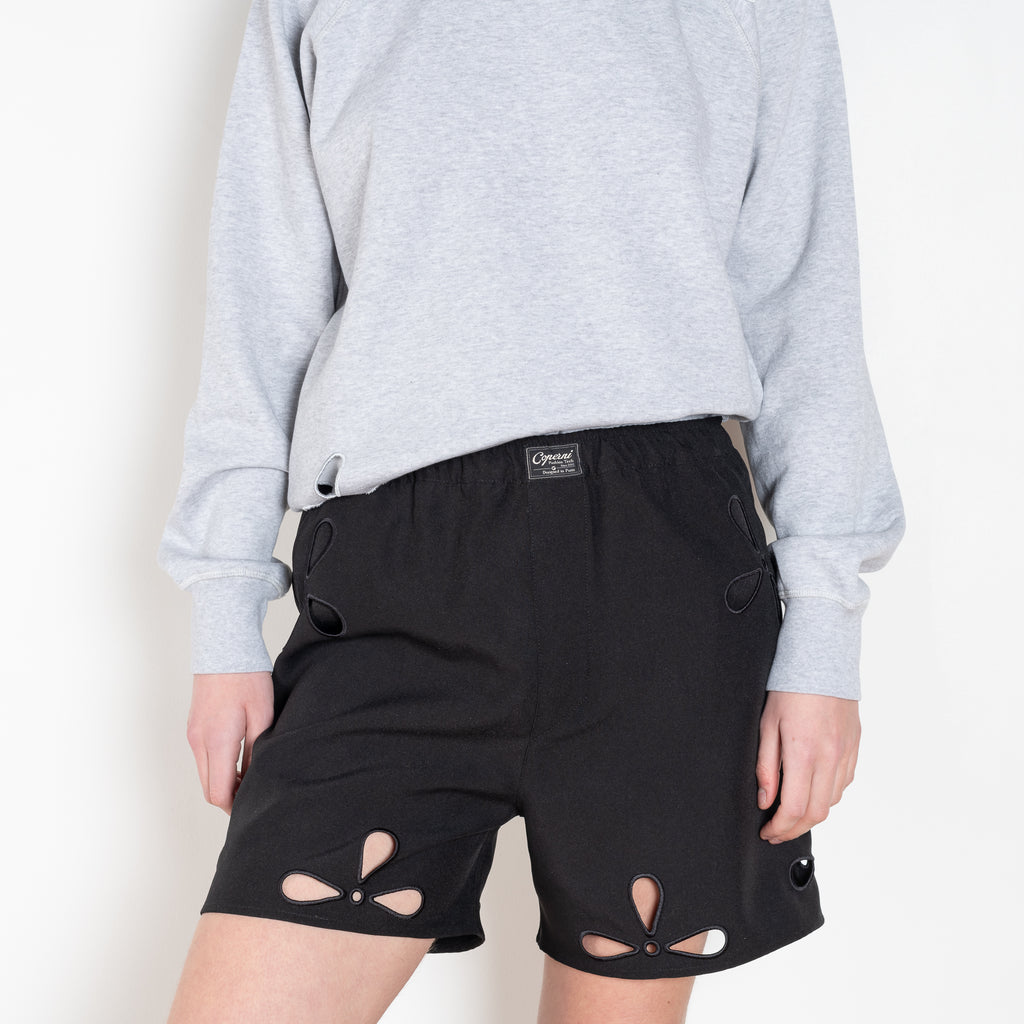 The Petal Embroidered Shorts by Coperni are boxer inspired shorts with a coperni logo patch and seasonal petal cut-outs