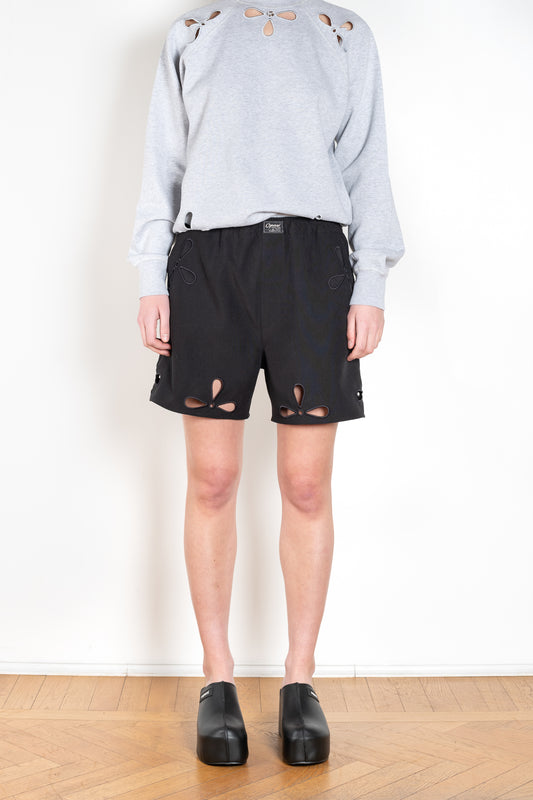 The Petal Embroidered Shorts by Coperni are boxer inspired shorts with a coperni logo patch and seasonal petal cut-outs