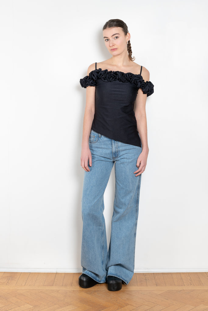 The Ruffle Top by Coperni is a fitted off-the-shoulder top with a ruffle neckline