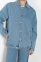 The Studded Denim Jacket by Coperni is a loose denim jacket with studded details and a front button closure