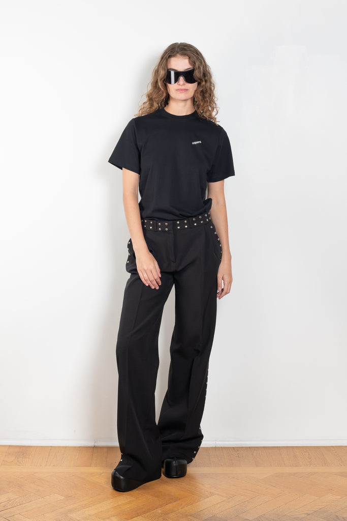 The Studded Tailored Trouser by Coperni is a mid rise trouser with a long wide leg and allover studs on the side and waistline