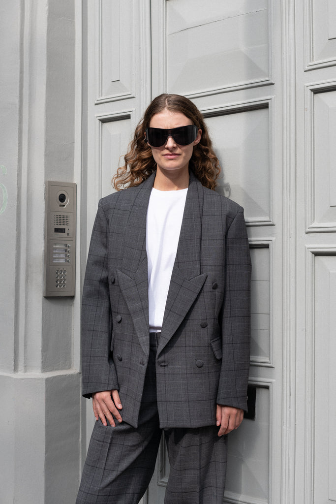 The Tailored Jacket by Coperni is a double breasted jacket with a relaxed fit in a seasonal windowpane check