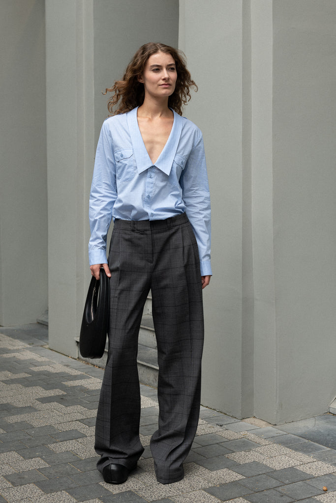 The Tailored Trouser by Coperni is a mid rise trouser with a long fluid wide leg in a seasonal windowpane check