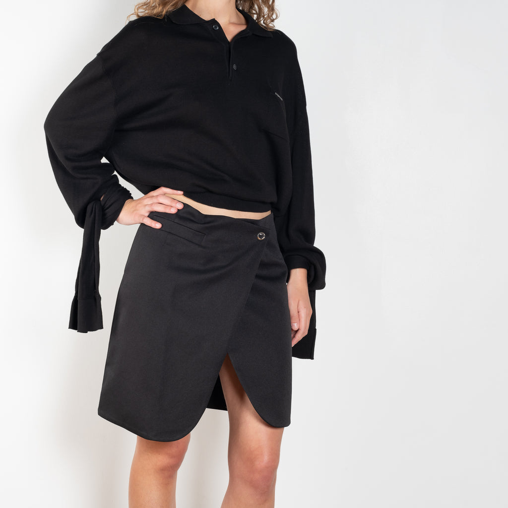 The Wraparound Skirt by Coperni is mid length wrap skirt with front slit with a Logo Hardware closure