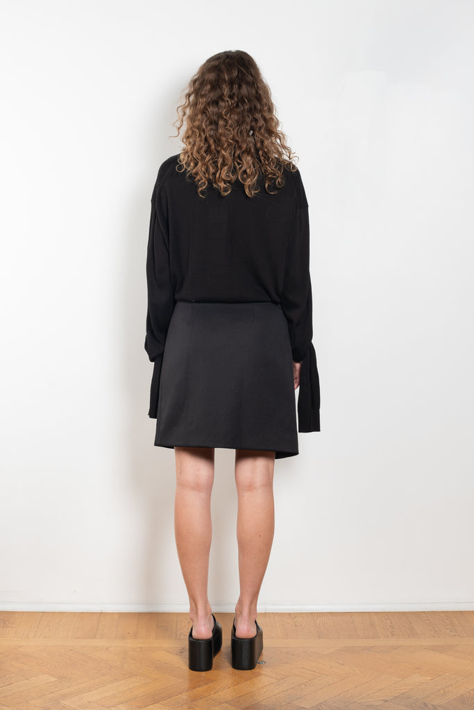 The Wraparound Skirt by Coperni is mid length wrap skirt with front slit with a Logo Hardware closure