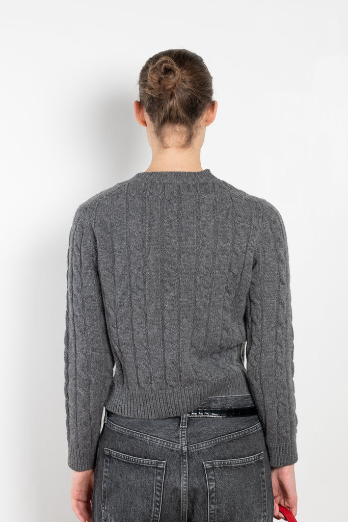 The Carrow Cable Crewneck is a crewneck sweater with a signature cable pattern and a shorter fitted silhouette