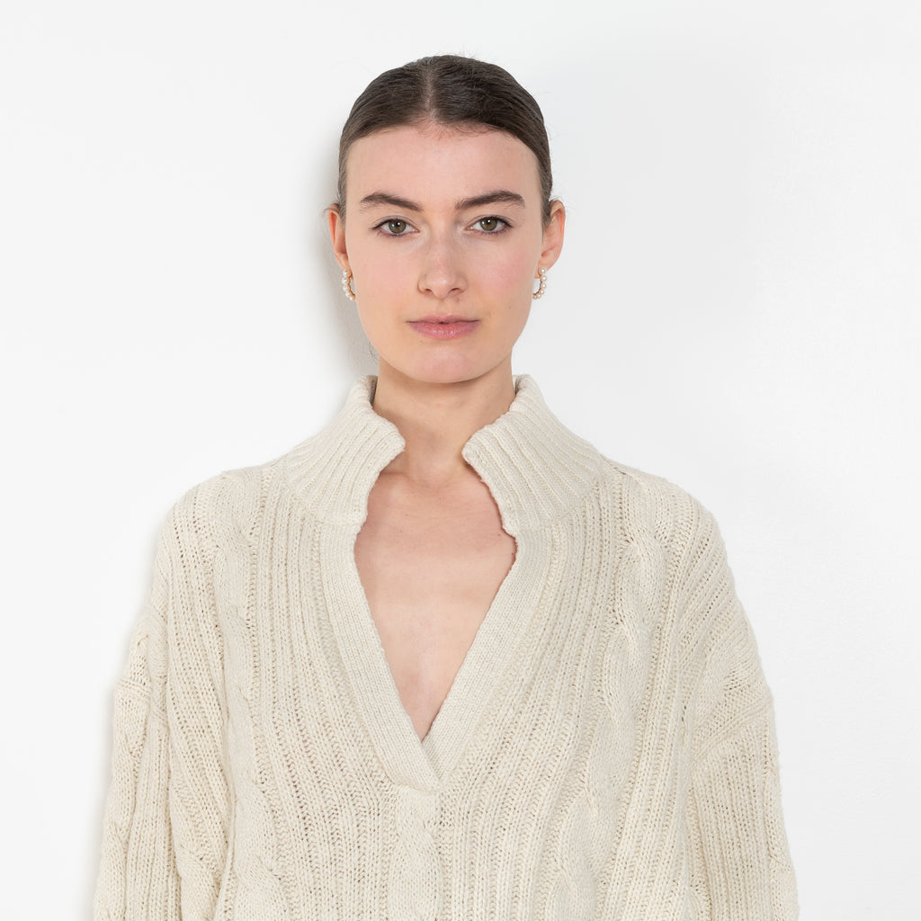 The Split Neck Cable Sweater By Denimist is a relaxed cable knit sweater in a soft cotton