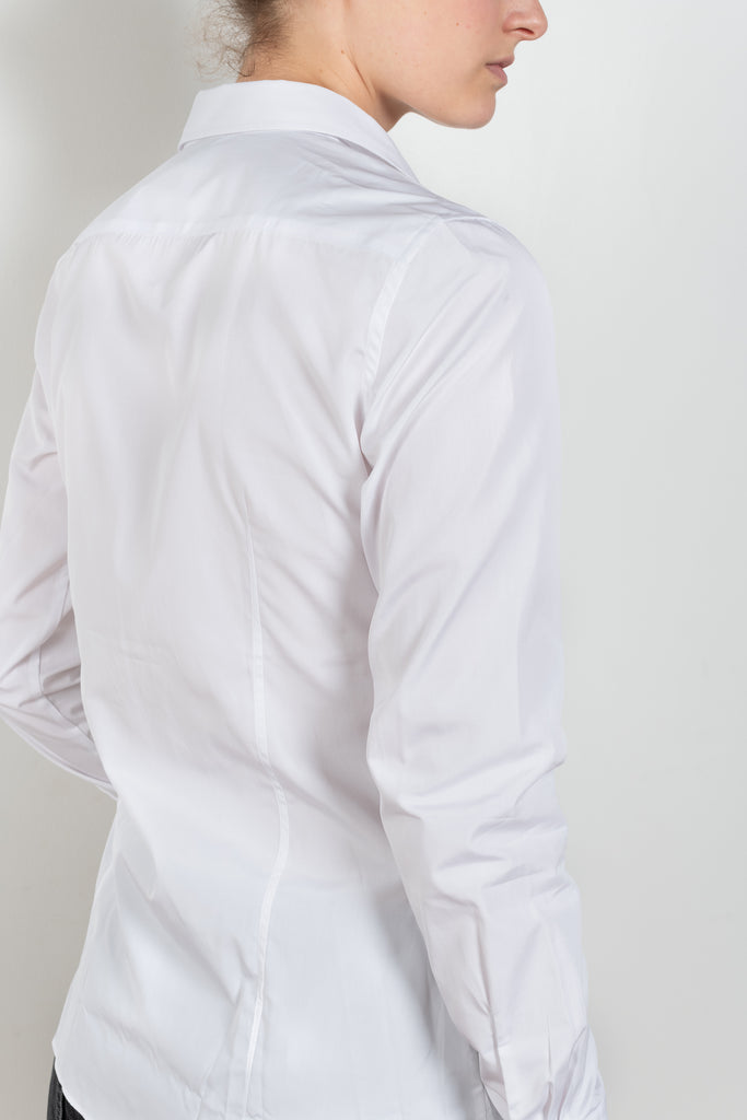 The Giulia Shirt by Flore Flore is a slim fitted shirt with a pointy collar and lengthened single buttoned cuffs with two pleats on the back