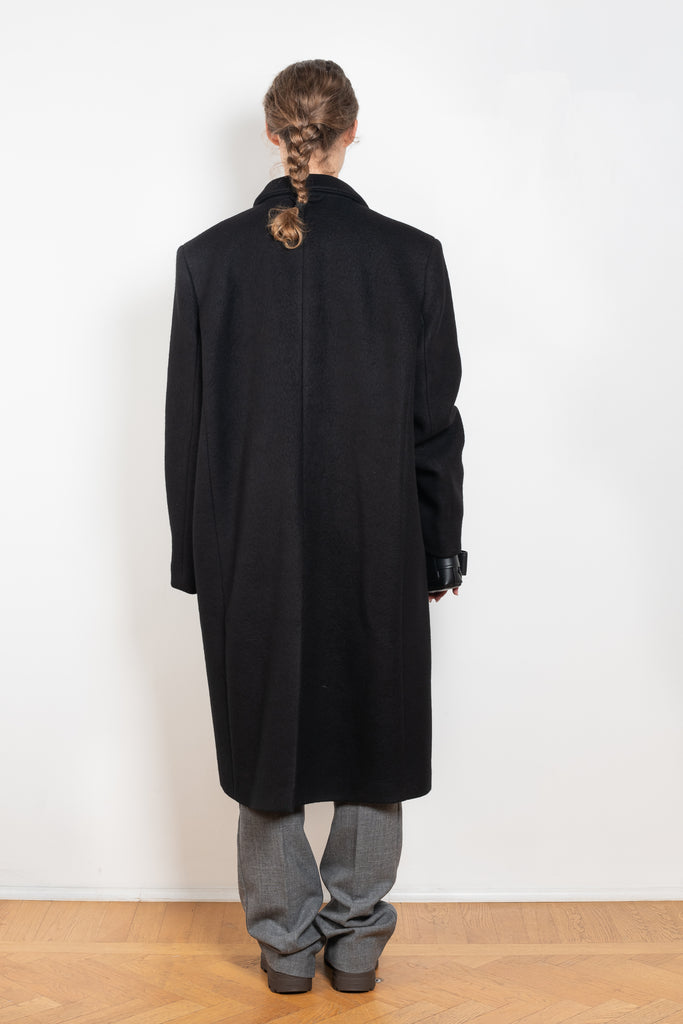 The Double Breasted Coat by KASSL Editions is a long coat crafted from boiled wool with classic men coat inspired detailing