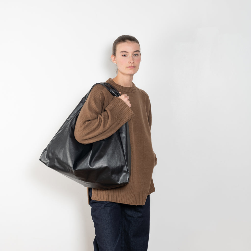 The Tote Shoulder Oil by Kassl Editions is crafted from the signature oil coated cotton-blend