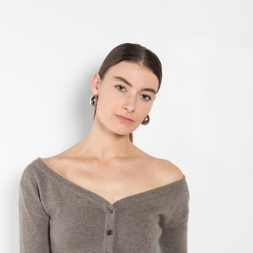 The Beata cardigan by LISA YANG is an off-the-shoulder cashmere cardigan with a cropped fitted silhouette