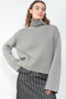 The Fleur Sweater by Lisa Yang has a relaxed silhouette with a loose high neck