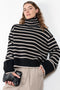 The Fleur Sweater by Lisa Yang has a relaxed silhouette with a loose high neck