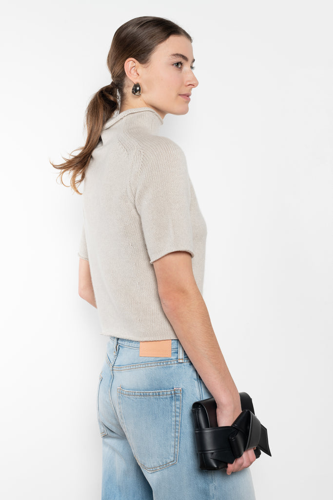 The Fride Sweater by LISA YANG has a standing mock-neck, with flattering, slim short sleeves and a cropped, regular fit.